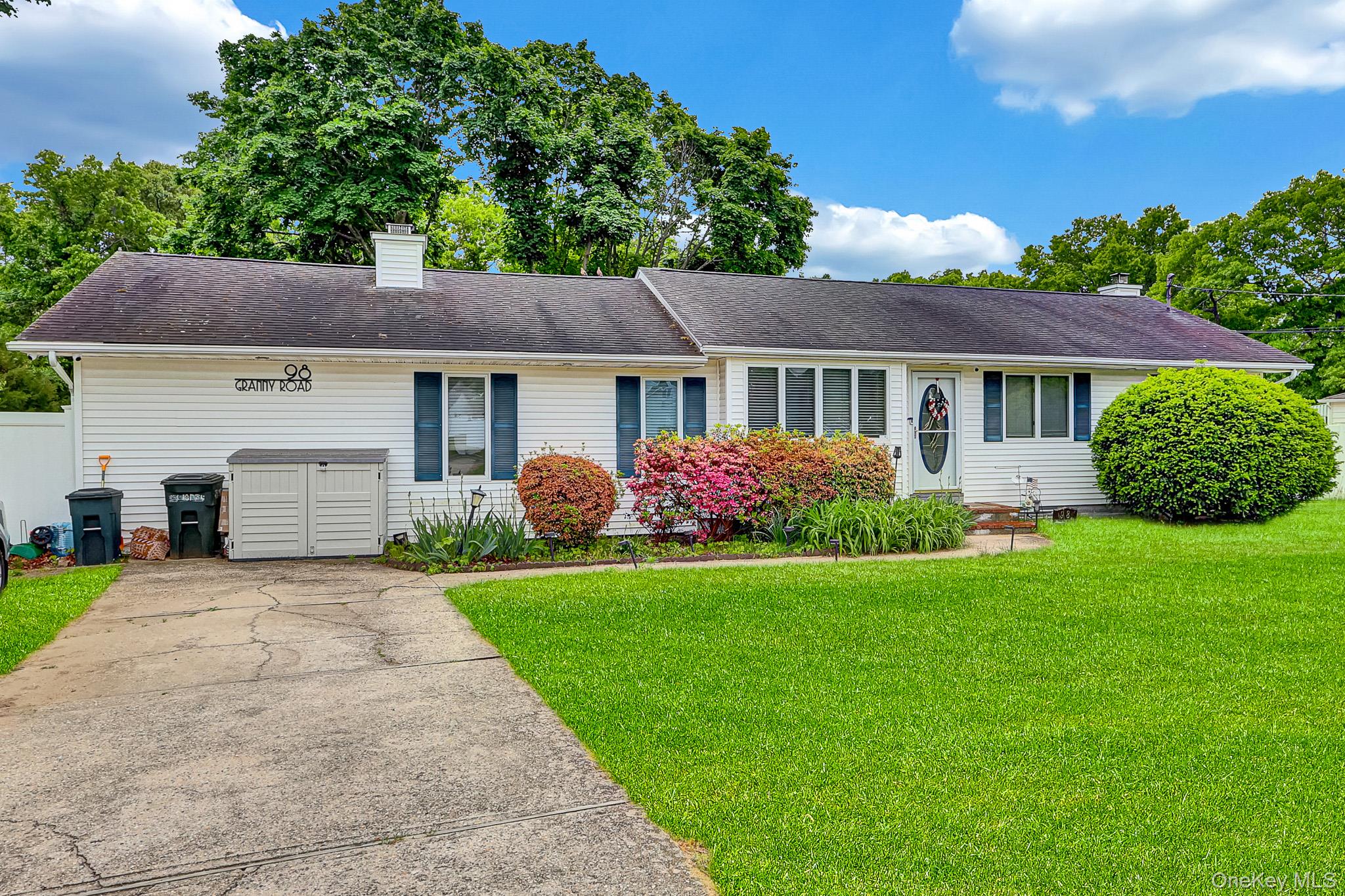 98 Granny Road Farmingville, NY 11738 - Photo 2 of 24 a front view of a house with a garden