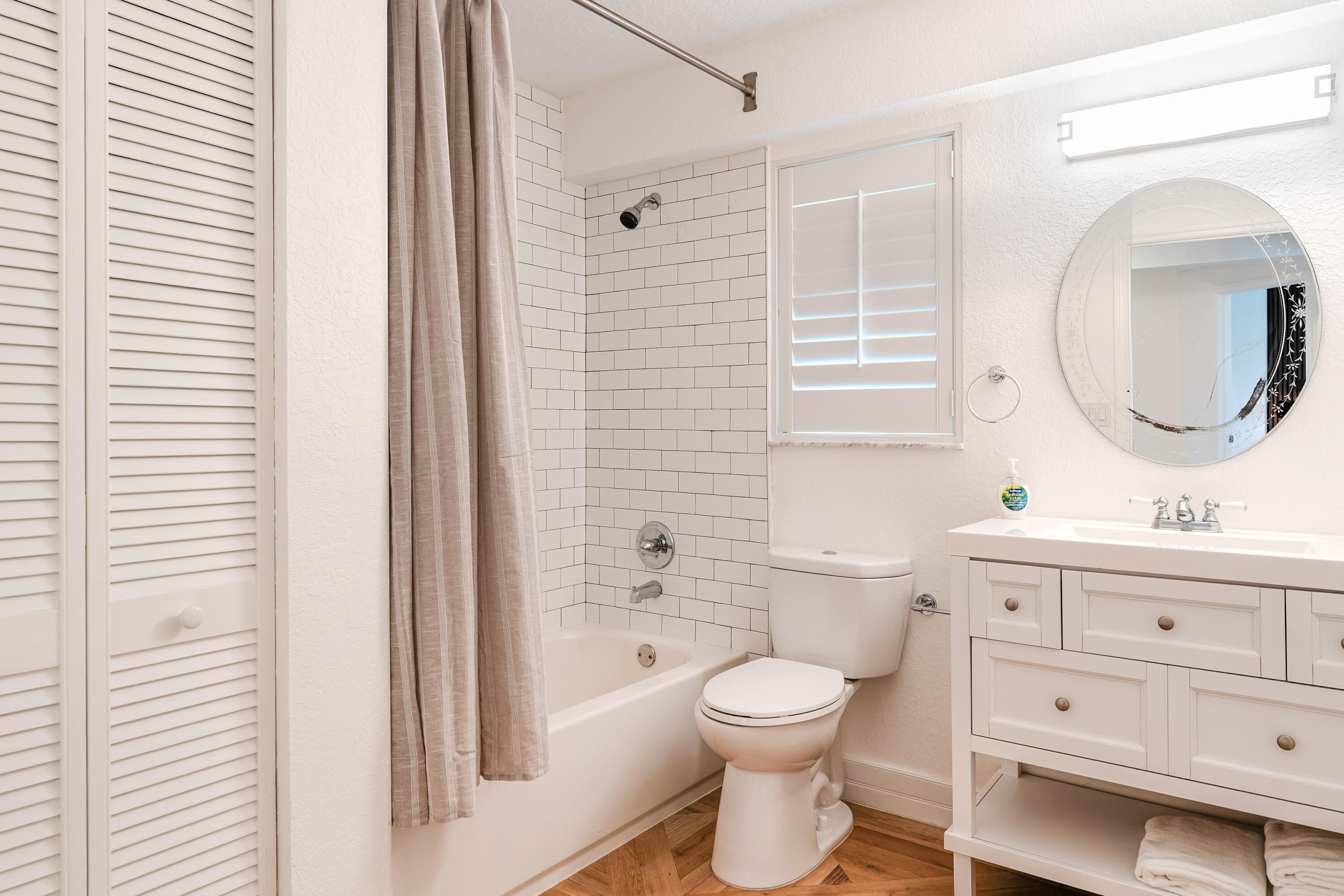 921 Ortega Road West Palm Beach, FL 33405 - Photo 40 of 60 a bathroom with a toilet a sink a mirror a shower a vanity and window