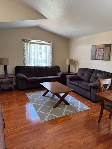 a living room with furniture window and wooden floor