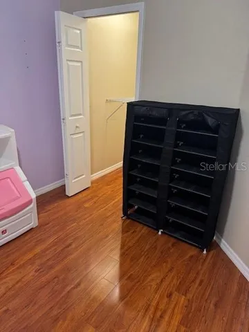 a view of room with wooden floor and closet
