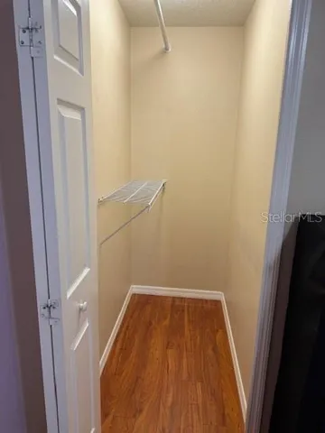 a view of a room with wooden floor