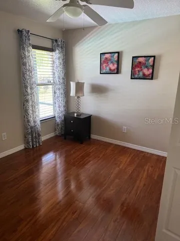 a view of workspace with wooden floor and window