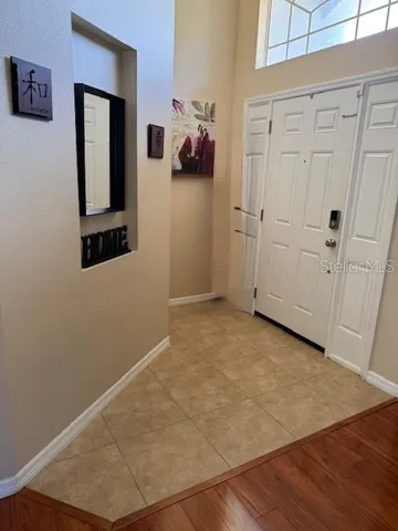 an entryway with wooden floor