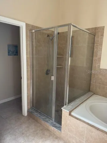 a bathroom with a shower and a tub