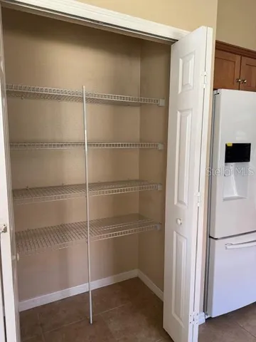 a white refrigerator freezer and a stove sitting inside of a kitchen