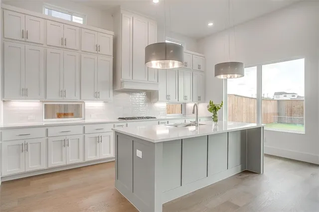 a kitchen with a sink cabinets and window