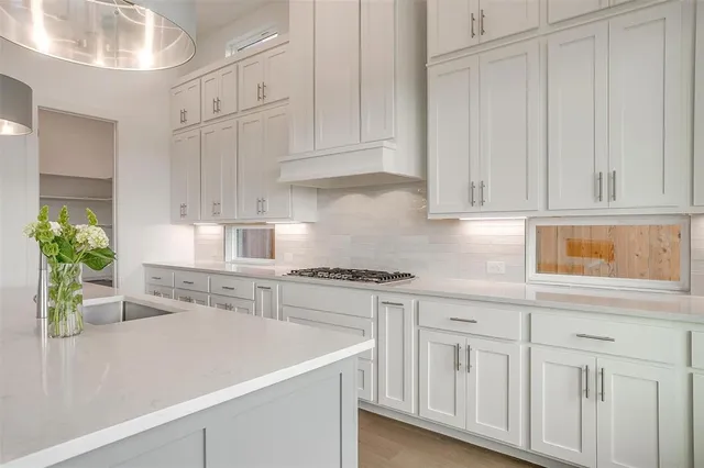 a kitchen with white cabinets and a sink