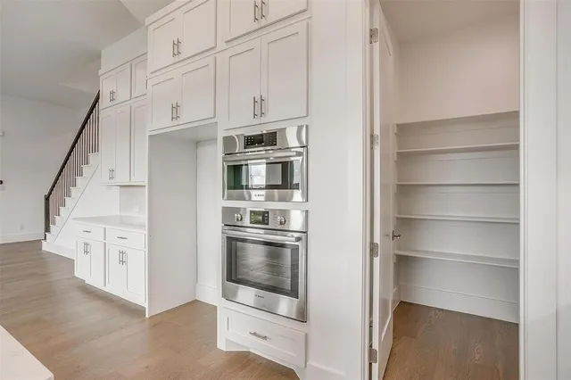 a kitchen with cabinets and a refrigerator