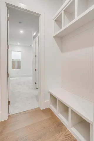 a bathroom with a bathtub shower sink vanity mirror and toilet