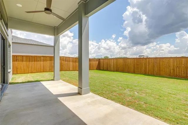 a view of an house with backyard space and balcony