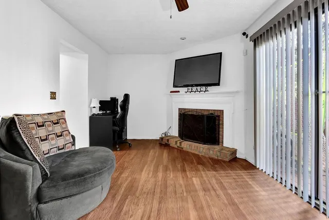 a living room with furniture fireplace and flat screen tv
