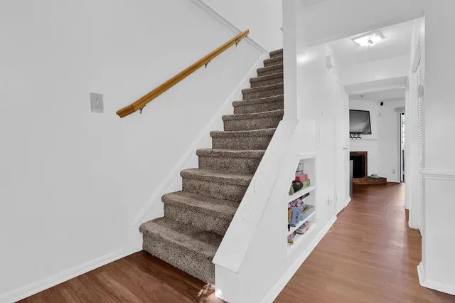 a view of entryway and hall with wooden floor