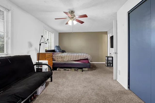 a bedroom with furniture and wooden floor