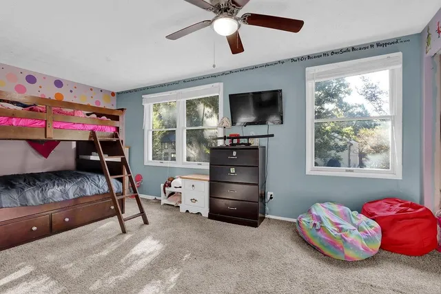 a bedroom with furniture and a window