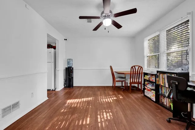 a view of a livingroom with furniture window wooden floor and entryway