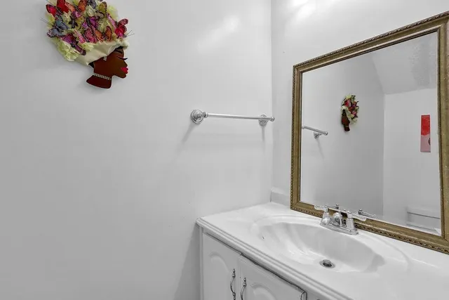 a bathroom with a sink vanity and mirror