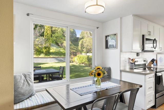 a view of a dining room with furniture window and outside view