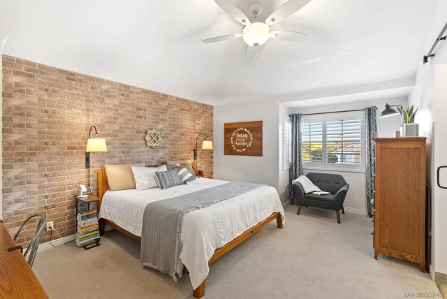 a bedroom with a bed chair and window