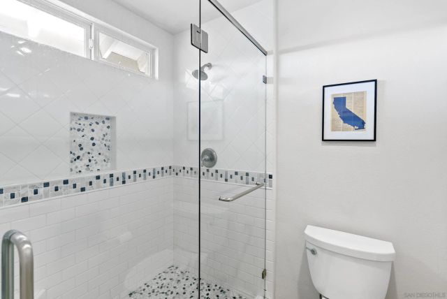 a bathroom with a shower a toilet and a shower