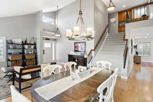 a view of a dining room with furniture and a chandelier