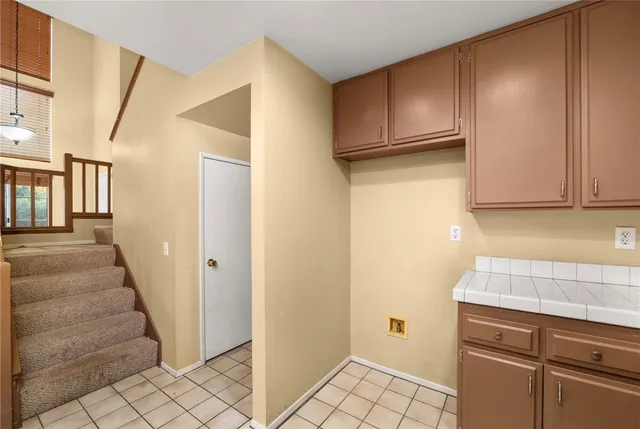 a kitchen with white cabinets and white appliances