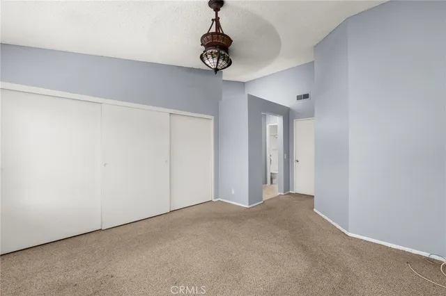 a view of a room with ceiling fan and window