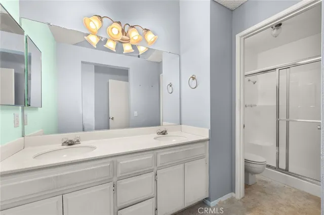 a bathroom with a sink double vanity and a mirror