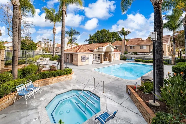 a front view of a house with a yard and potted plants