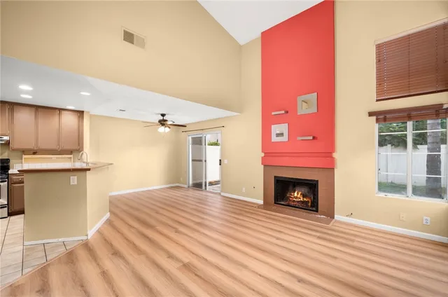 a view of empty room with wooden floor and fireplace
