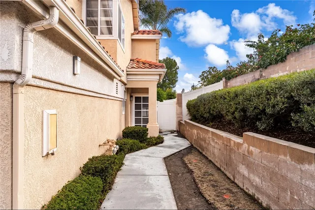 a front view of a house with plants