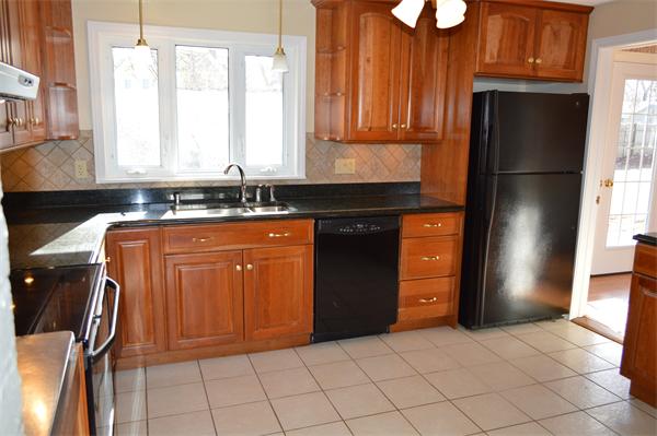 25 Wedgemere Road Beverly, MA 01915 - Photo 14 of 22 a kitchen with stainless steel appliances granite countertop a refrigerator and a sink