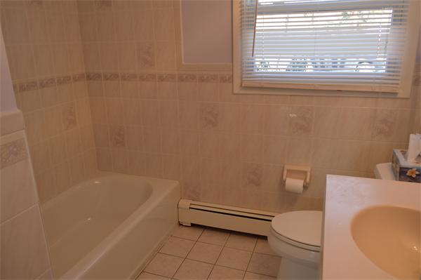 25 Wedgemere Road Beverly, MA 01915 - Photo 21 of 22 a bathroom with a toilet and a bathtub