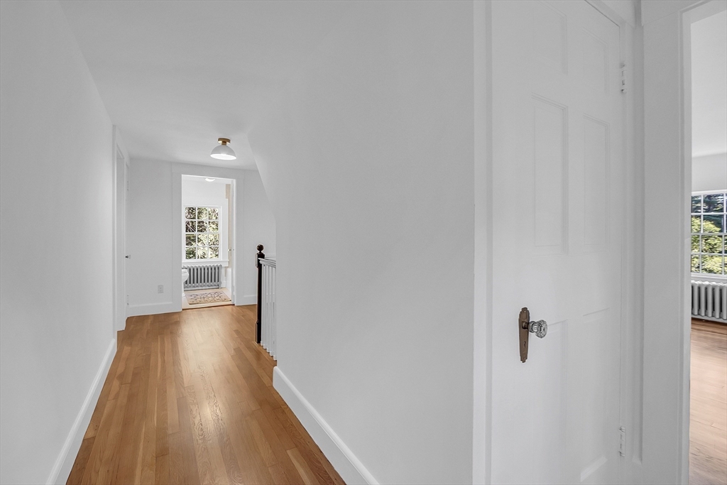 681 Barretts Mill Road Concord, MA 01742 - Photo 17 of 27 a view of a hallway with wooden floor and staircase