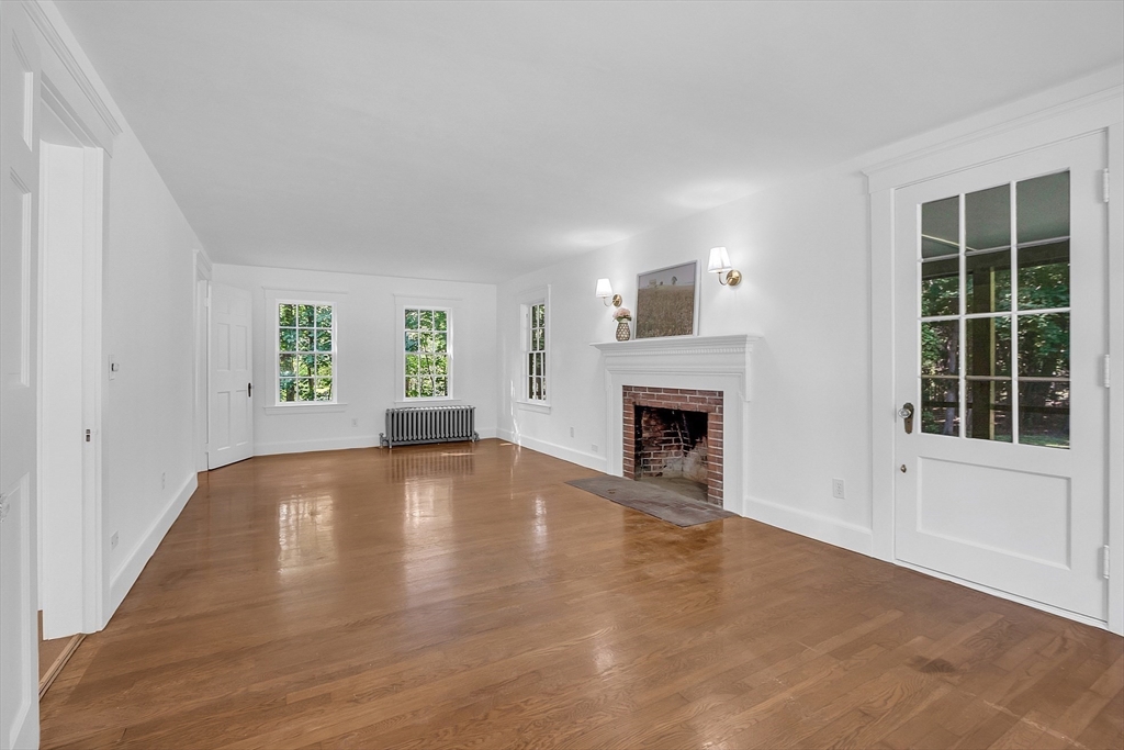 681 Barretts Mill Road Concord, MA 01742 - Photo 3 of 27 a view of an empty room with a window and fireplace