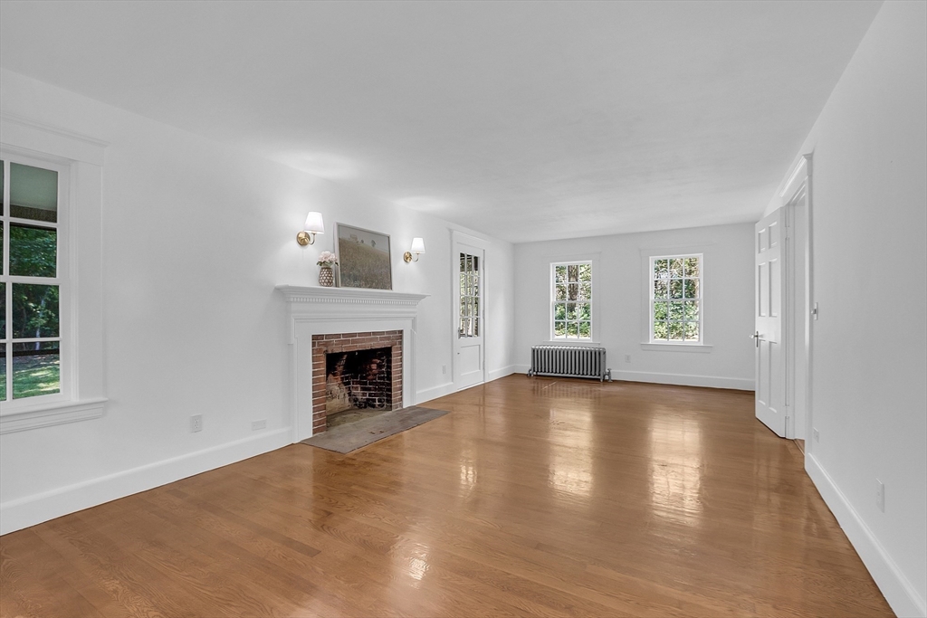 681 Barretts Mill Road Concord, MA 01742 - Photo 4 of 27 a view of an empty room with a window and fireplace