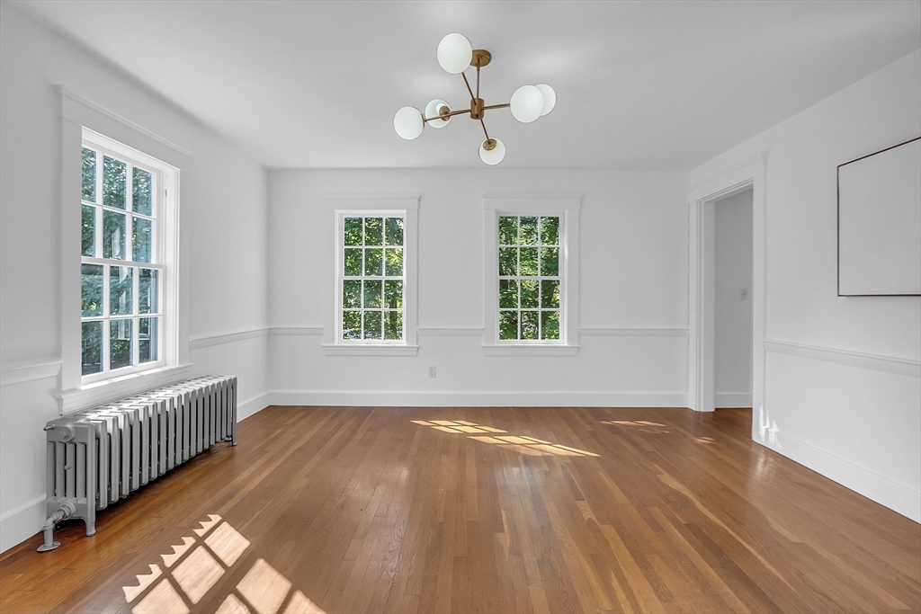 681 Barretts Mill Road Concord, MA 01742 - Photo 5 of 27 a view of an empty room with wooden floor and a window