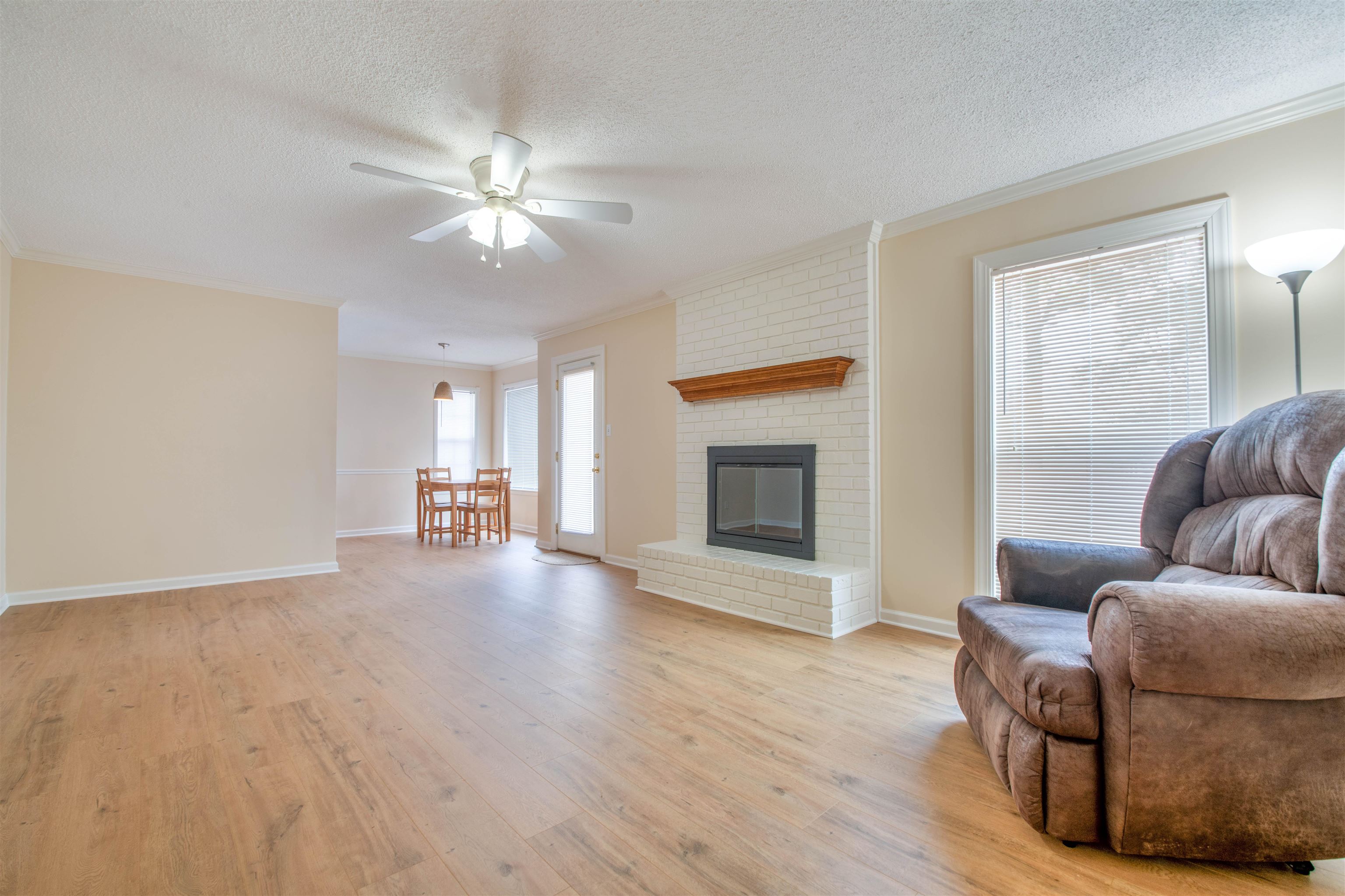 1642 Brierbrook Road Germantown, TN 38138 - Photo 11 of 37 Den ornamental molding, a brick fireplace, ceiling fan, and light hardwood / wood-style flooring