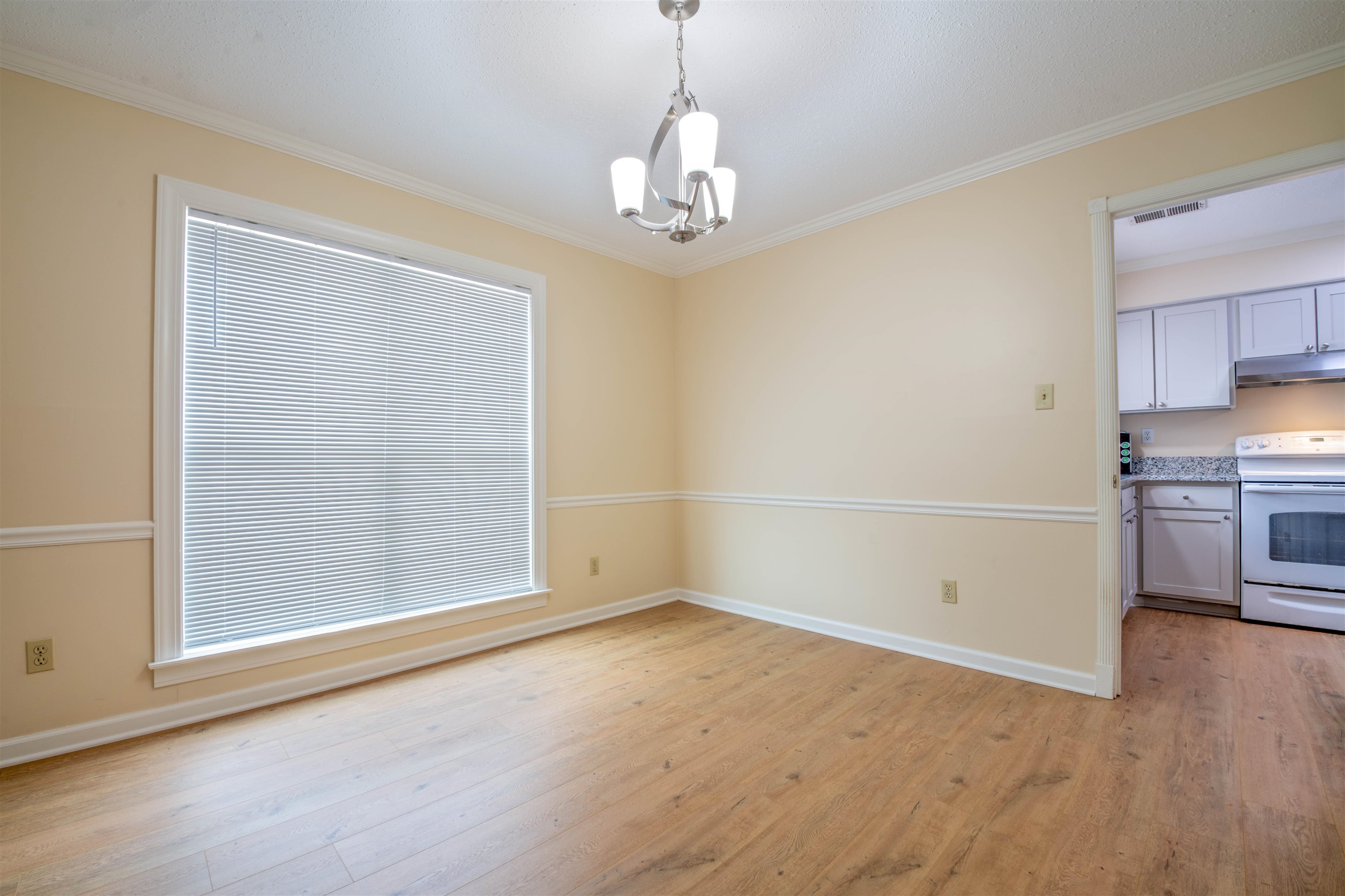 1642 Brierbrook Road Germantown, TN 38138 - Photo 17 of 37 Unfurnished dining area featuring light wood-type flooring, crown molding, and a notable chandelier