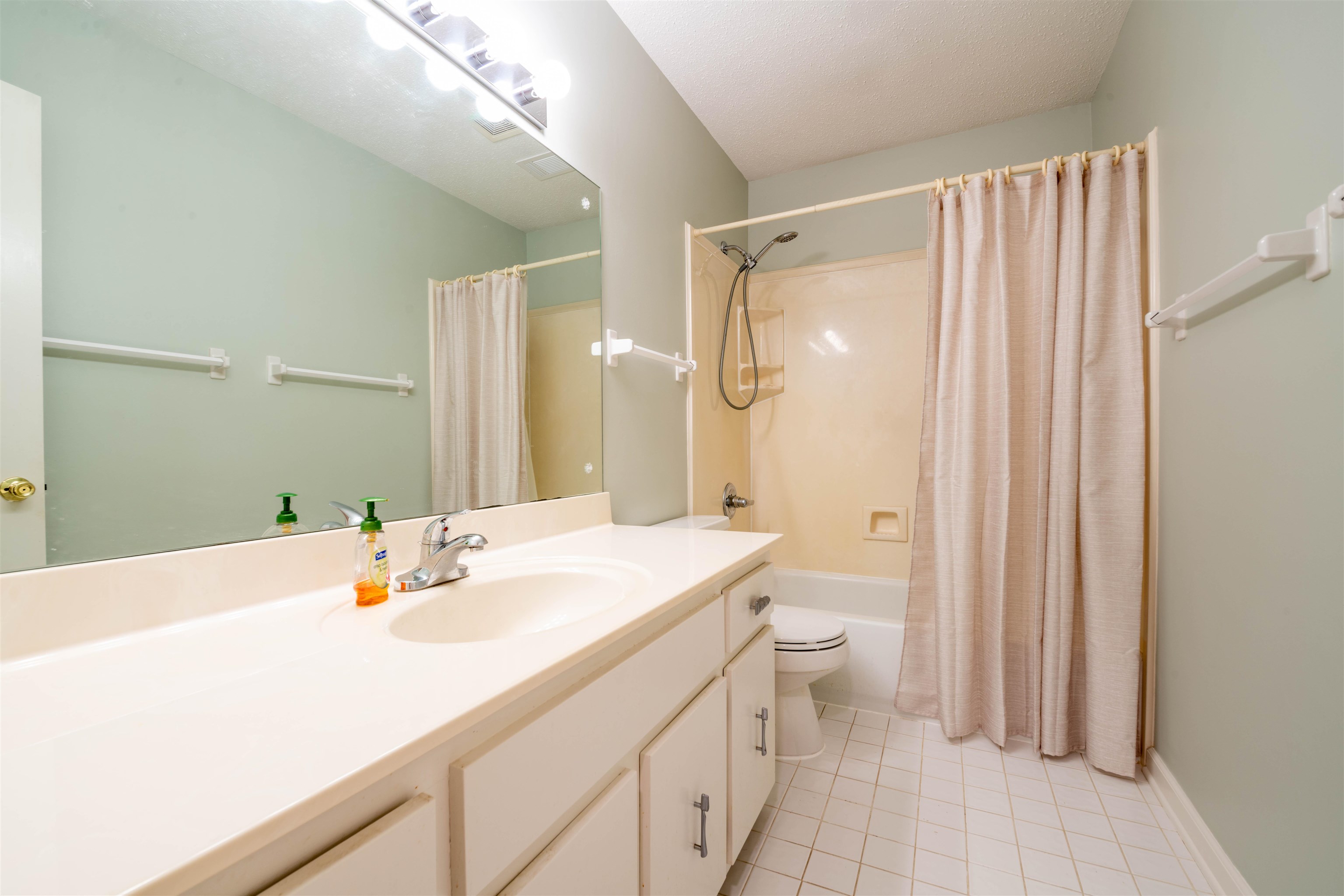 1642 Brierbrook Road Germantown, TN 38138 - Photo 28 of 37 Bathroom featuring tile patterned flooring, vanity, toilet, and shower / bath combo with shower curtain