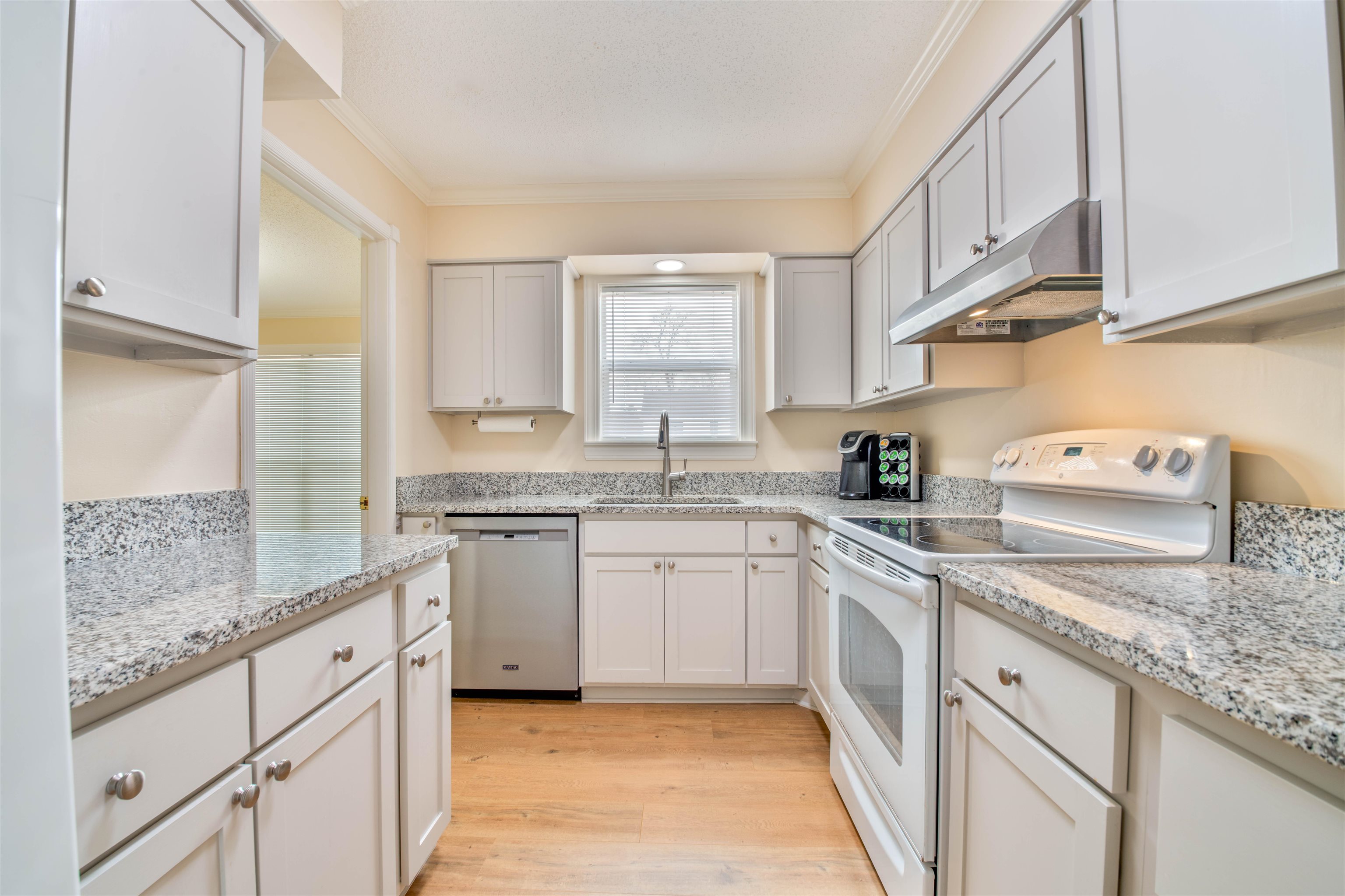 1642 Brierbrook Road Germantown, TN 38138 - Photo 5 of 37 Kitchen with dishwasher, crown molding, white electric range oven, sink, and white cabinetry