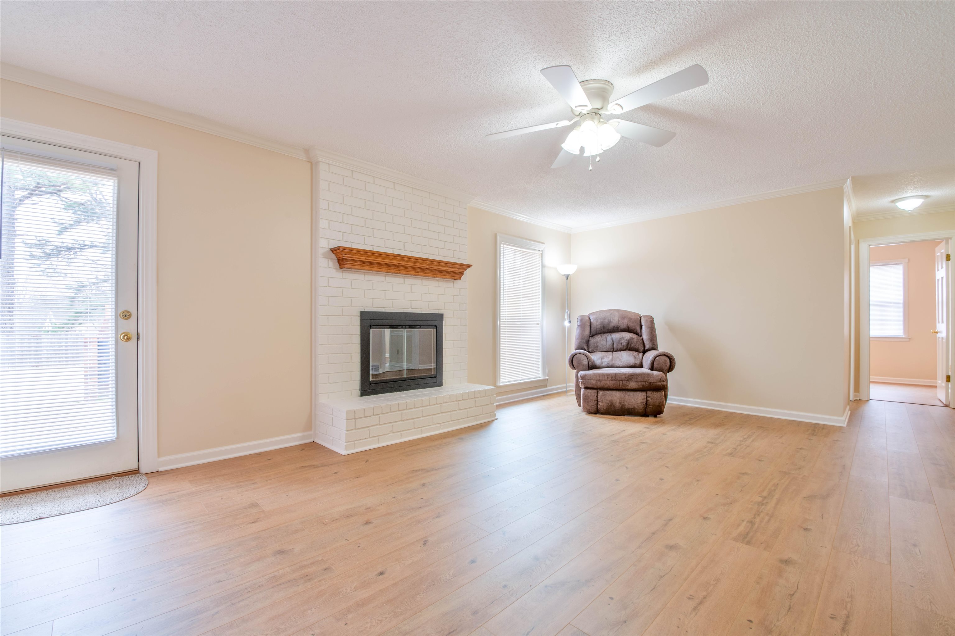 1642 Brierbrook Road Germantown, TN 38138 - Photo 10 of 37 Den/room featuring light wood-type flooring, crown molding, and a textured ceiling