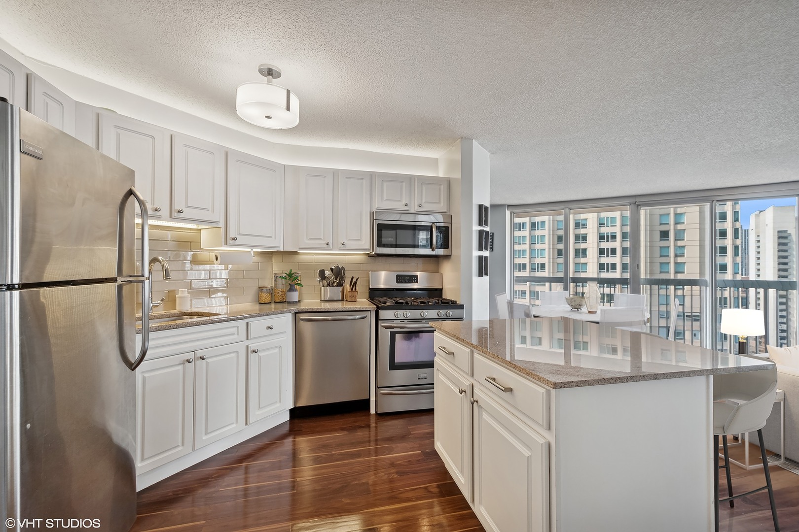 545 North Dearborn Street, Unit 1904 Chicago, IL 60654 - Photo 8 of 35 a kitchen with stainless steel appliances granite countertop a refrigerator a stove top oven a sink and dishwasher