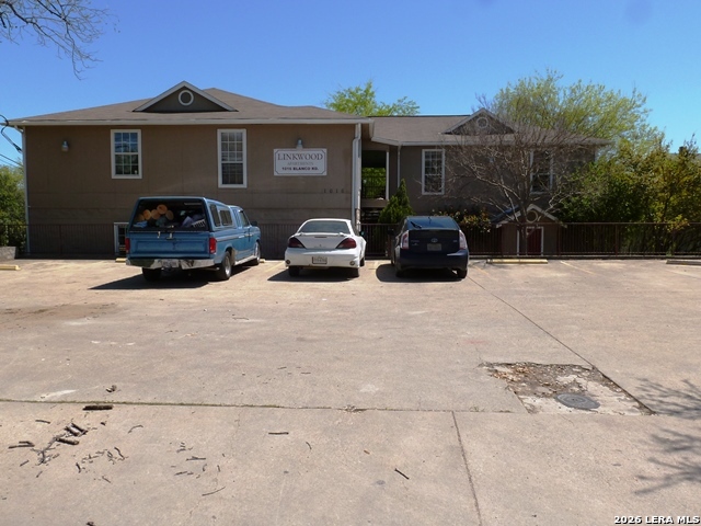 a couple of cars parked in front of a house