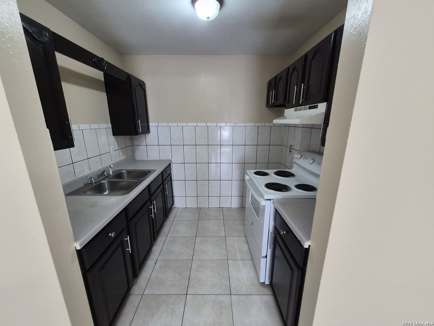 1016 Blanco Road, Unit 104 San Antonio, TX 78212 - Photo 9 of 23 a kitchen with a sink a stove top oven a sink and dishwasher