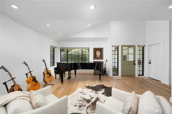 a kitchen with stainless steel appliances a white table chairs and a refrigerator