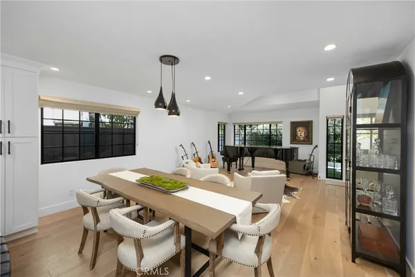 a living room with furniture large windows and a fireplace