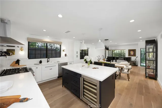 a bathroom with a sink a mirror a glass door and shower
