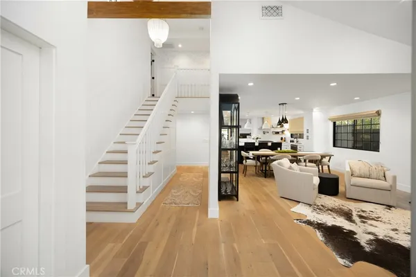 a living room with furniture large window and flat screen tv