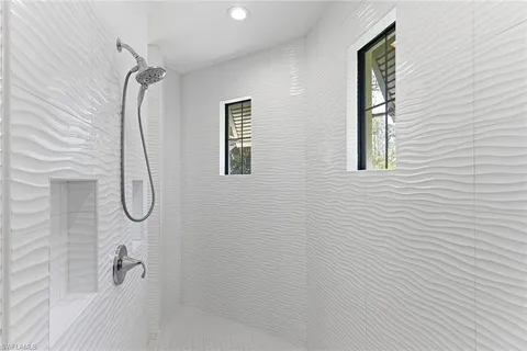 a bathroom with a glass shower door