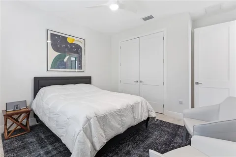 a bedroom with a bed and a painting on the wall